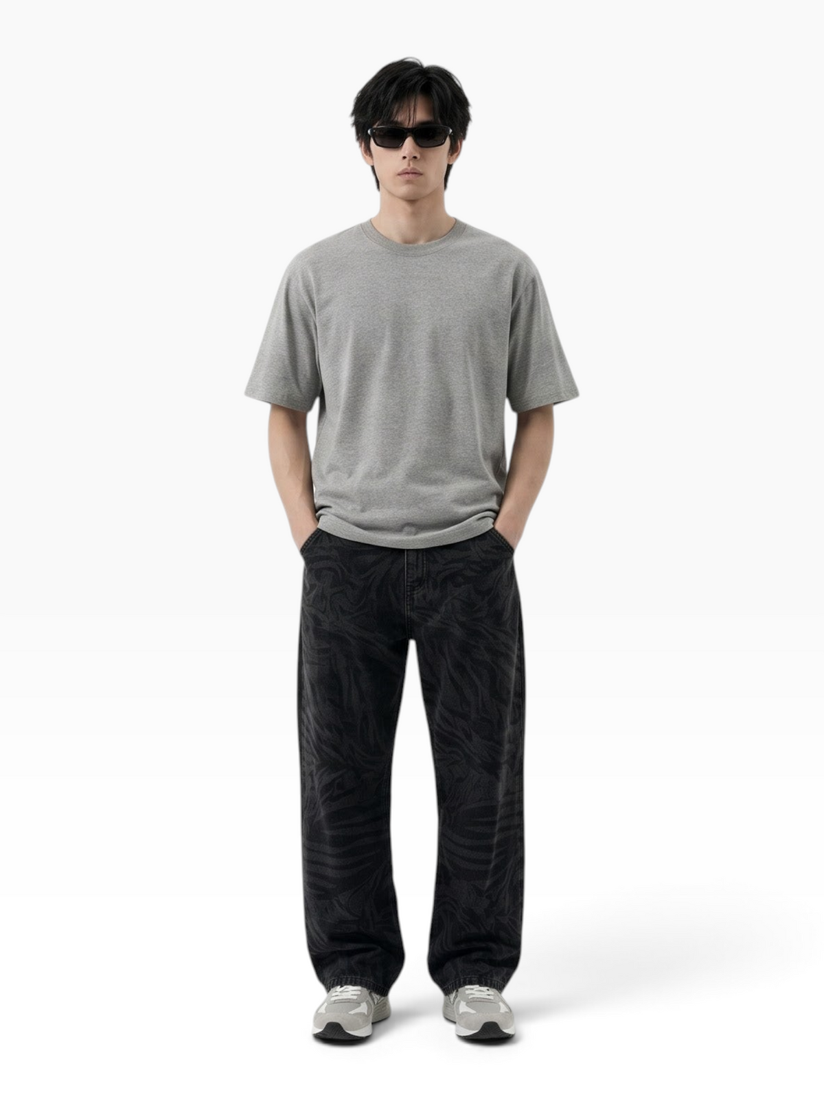 E7 unisex oversized grey cotton t-shirt worn by a man with sunglasses and patterned black trousers