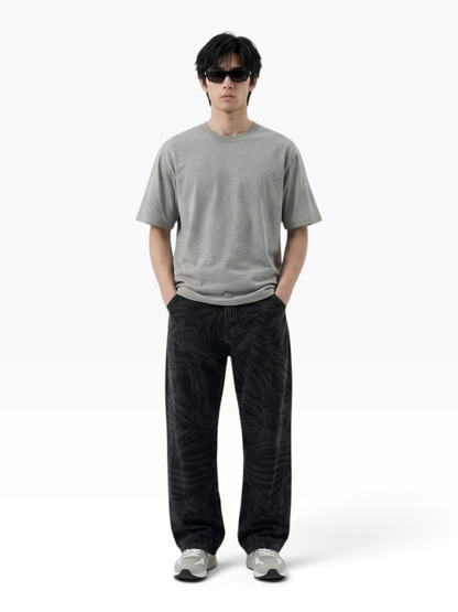 E7 unisex oversized grey cotton t-shirt worn by a man with sunglasses and patterned black trousers