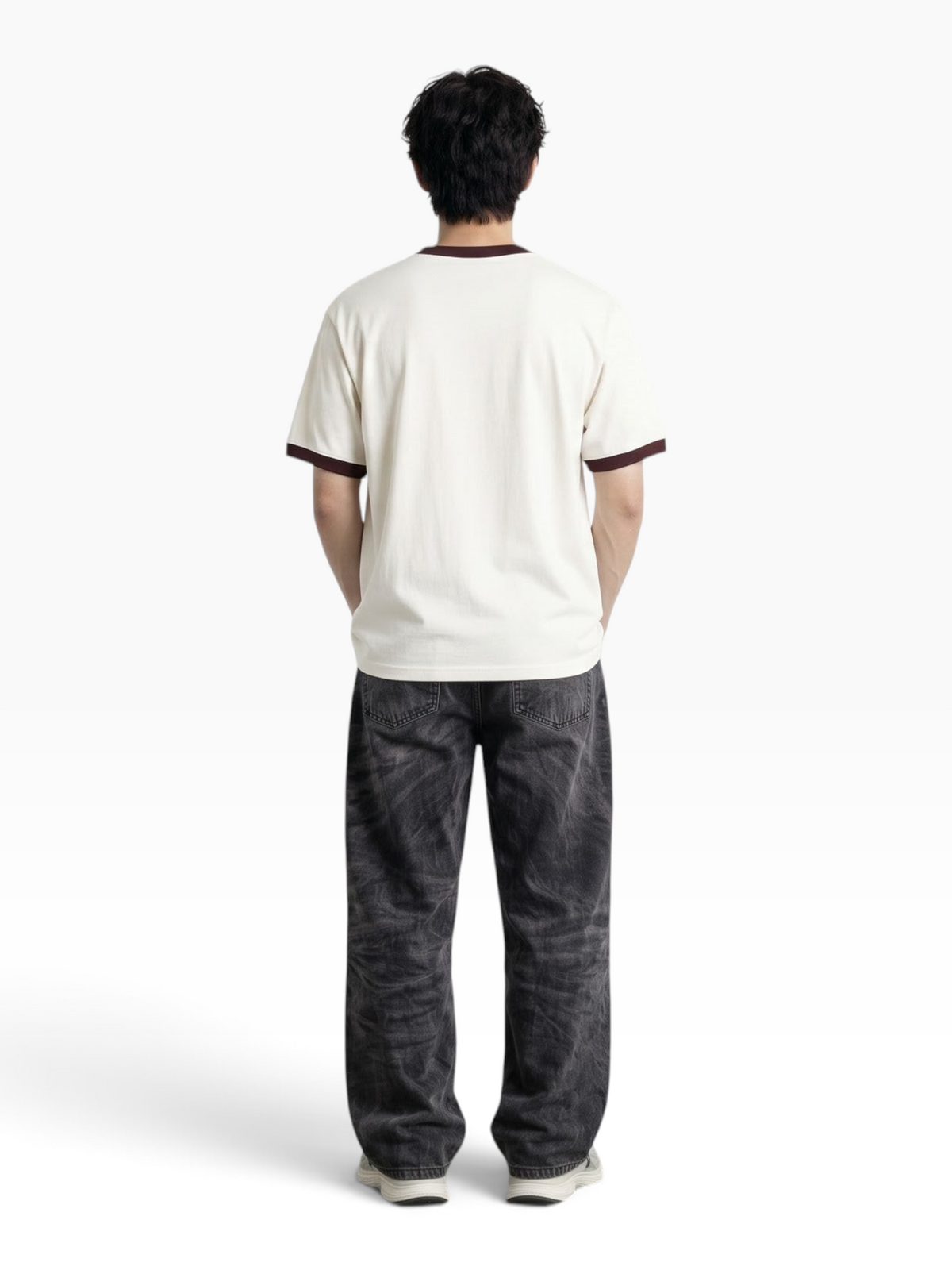 Back view of a man wearing an E7 unisex off-white ringer t-shirt with dark brown trim and relaxed fit jeans.