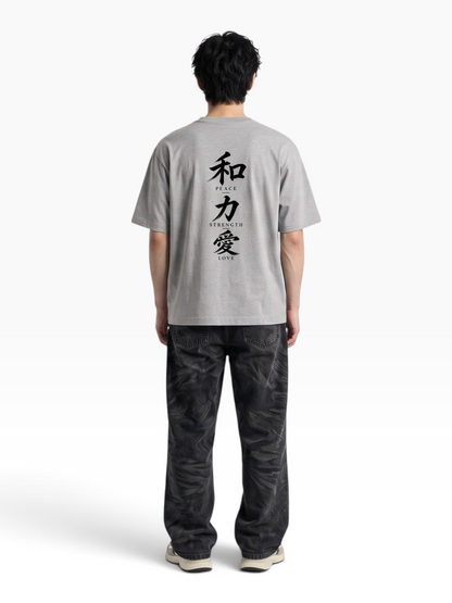 E7 unisex oversized grey cotton t-shirt with Japanese kanji and English text print on the back, worn by a man