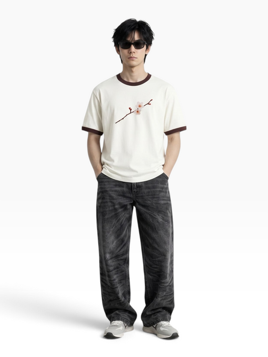 E7 unisex ringer t-shirt in cream with brown ribbed neck and sleeves, featuring a floral graphic, worn by a model.
