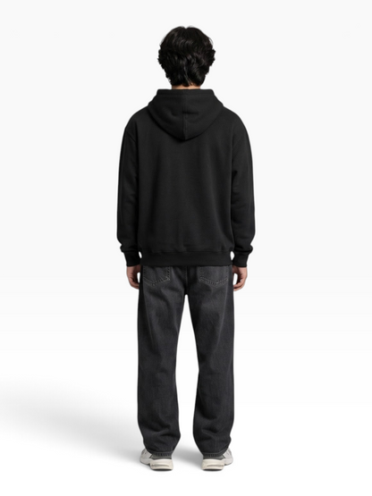 E7 unisex regular fit black cotton blend pullover hoodie worn by a man, back view against a grey background.