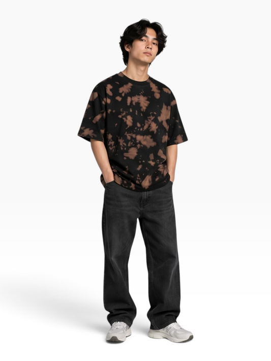 E7 unisex oversized tie-dye t-shirt in black and brown cotton blend worn by a man with dark jeans and sneakers