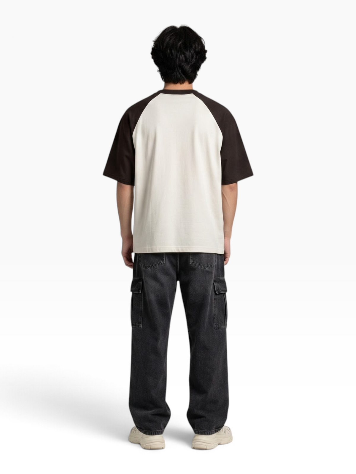 Back view of a person wearing an E7 oversized raglan t-shirt with cream body and dark brown sleeves.