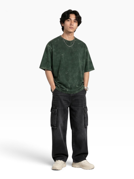 E7 unisex oversized heavyweight cotton t-shirt in dark green acid wash worn by a model with black cargo pants