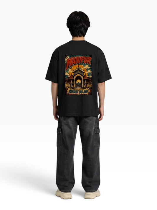 E7 unisex oversized black cotton t-shirt with Manipur graphic print on back worn by a man from behind